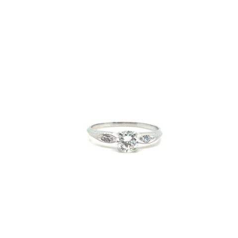 Platinum round brilliant diamond solitaire ring, approx. 0.73 ct I/VVS center stone, single-cut diamond accents in navette-profile cutout shoulders, plain polished shank, size 8.5
