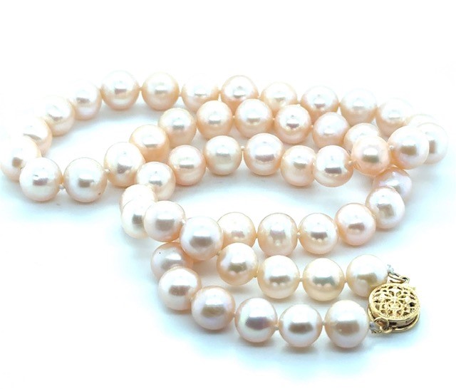Yellow gold-filled cultured freshwater pearl strand necklace, 54 peachy-pink pearls graduating 7.5–8.5mm, hand-knotted silk cord, filigree ball clasp, 18" length