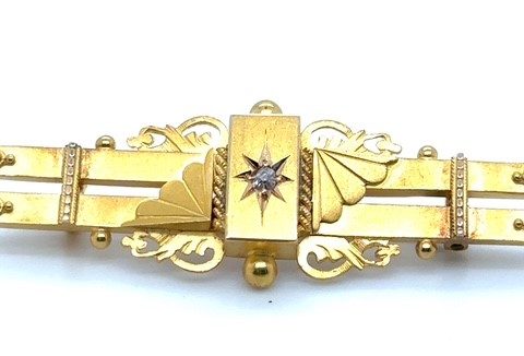 15K yellow gold old mine cut diamond late Victorian bar brooch, star-set diamond center cartouche, Aesthetic Movement fan and scrollwork flanking motifs, applied bead and rope detailing, ball terminal finials, pin back