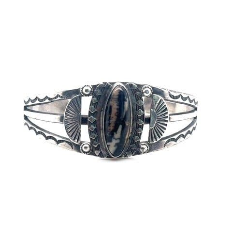 Native American sterling silver cuff bracelet with bezel set petrified wood and stamped fan details
