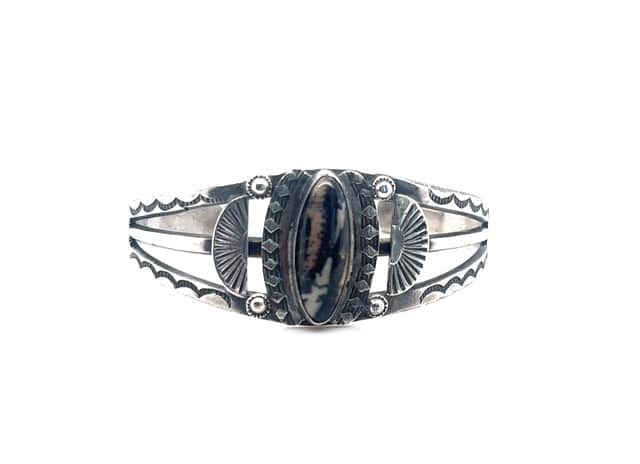 Native American sterling silver cuff bracelet with bezel set petrified wood and stamped fan details