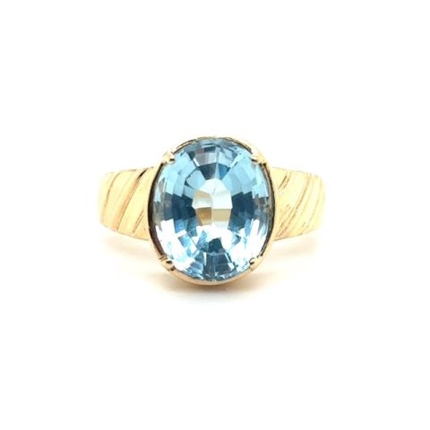 14K yellow gold ring with oval blue topaz and ribbed shank