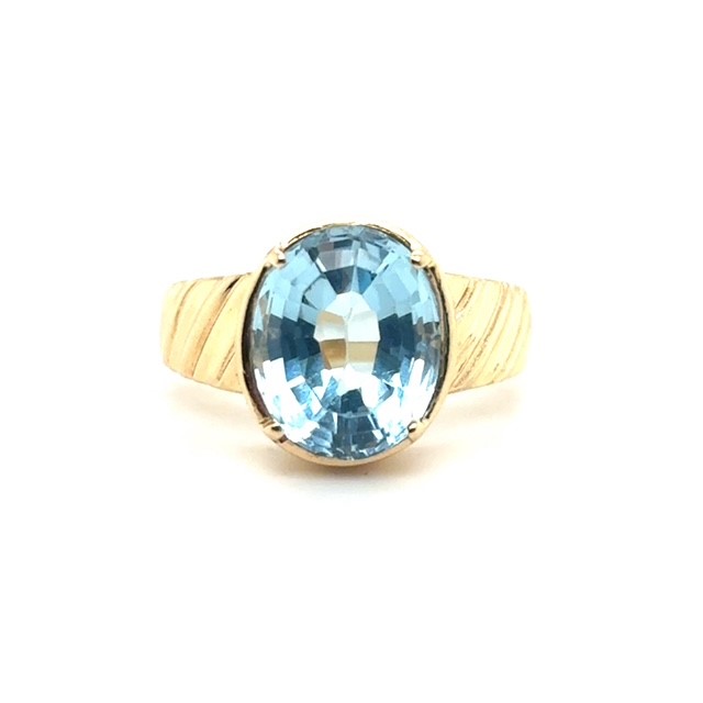 14K yellow gold ring with oval blue topaz and ribbed shank